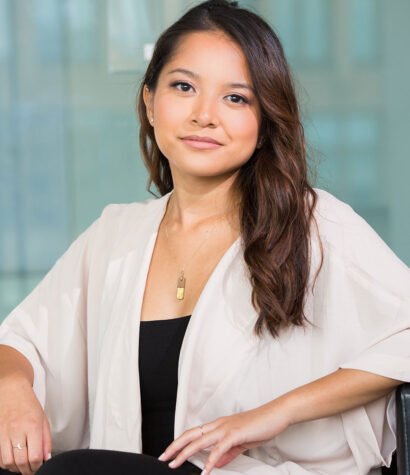 Megan Oustin, Senior Android Developer at Solo Performance LLC, seated in a professional office setting, showcasing expertise in dealership training solutions.