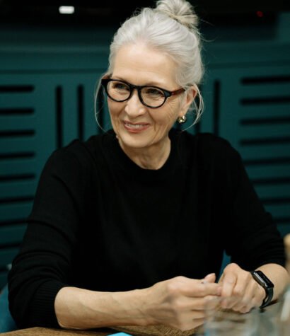 Senior consulting developer engaging in discussion, showcasing expertise and collaboration in a professional setting related to dealership training solutions.